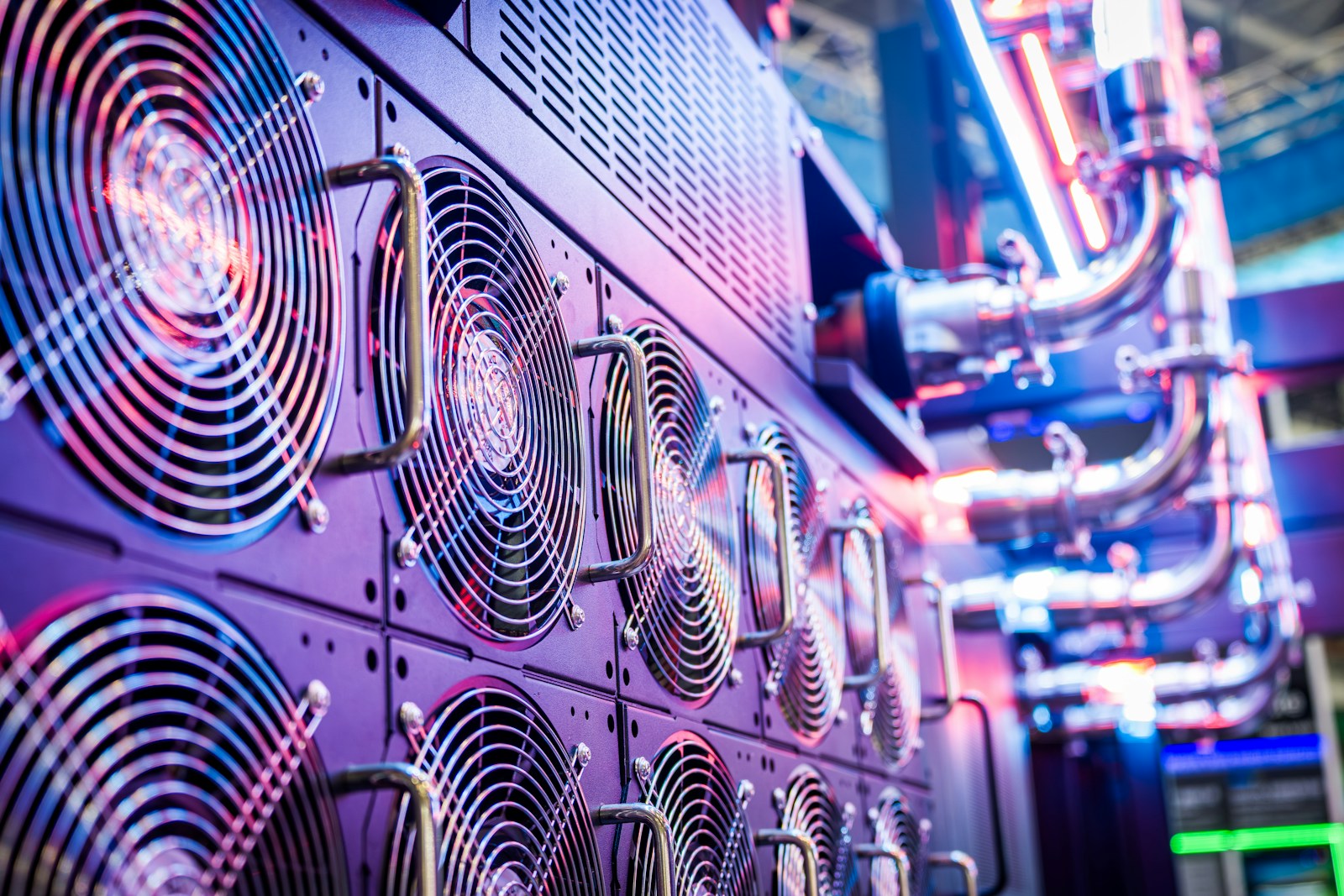Close-up of server cooling fans lit in low blue light inside a data center
